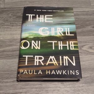 The Girl on the Train, a hardcover book written by Paula Hawkins